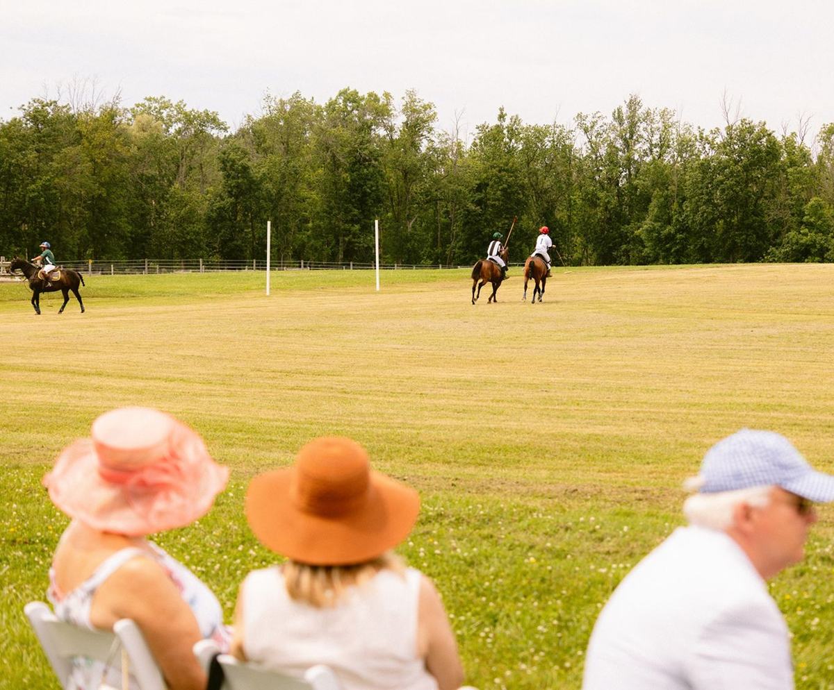 Guests watching polo on the field at Legacy Equestrian Center